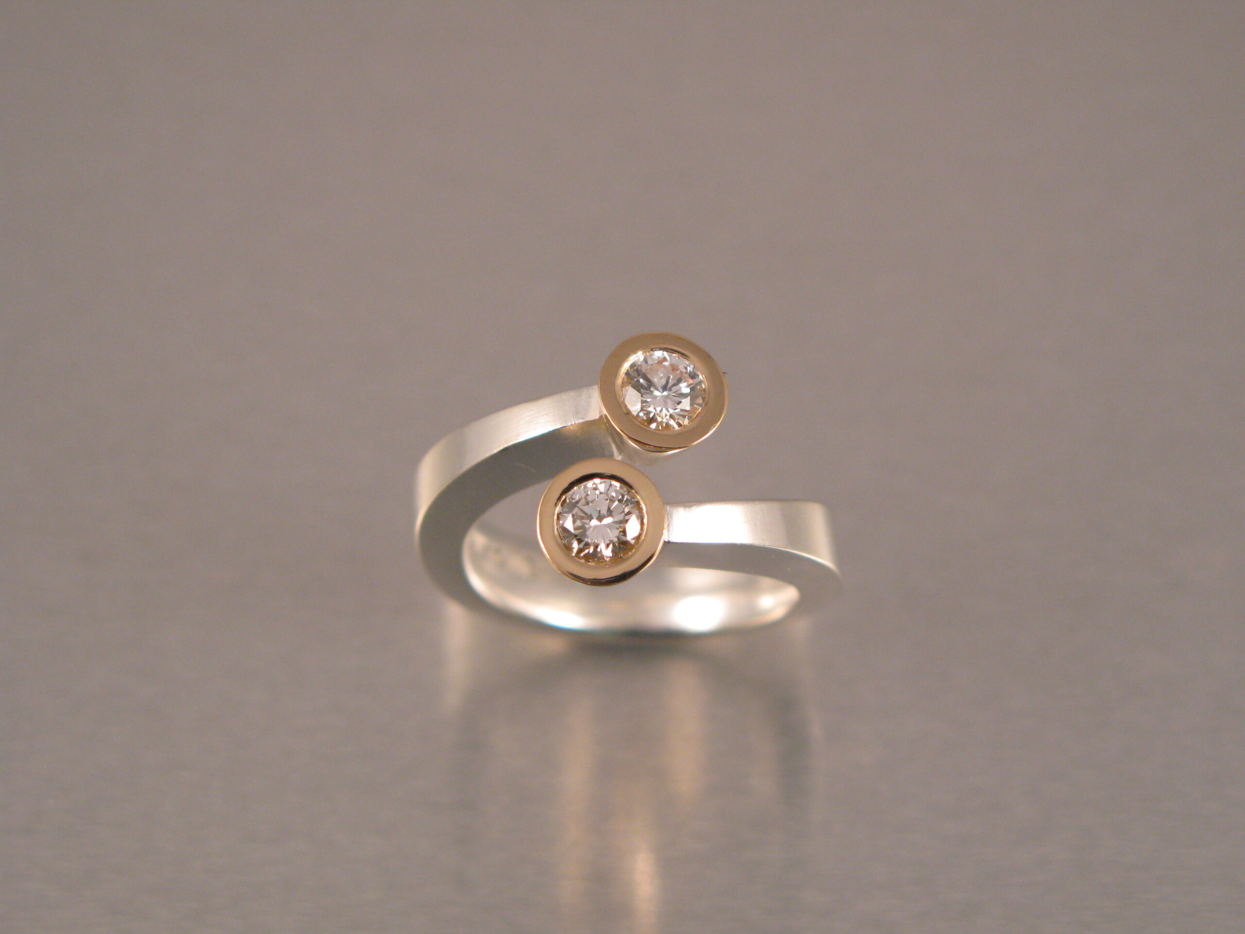 Ring, ”Omlottring”, silver, guld, vit och brun briljant